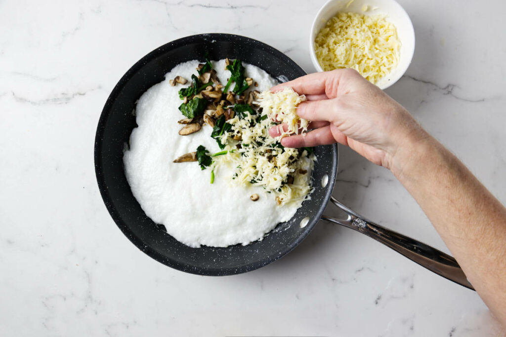 Placing mushrooms, spinach and cheese on the egg white omelette.