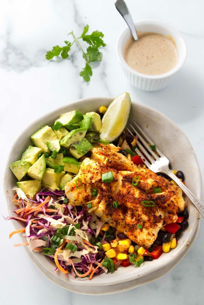 A fish taco bowl with corn and bean salsa.