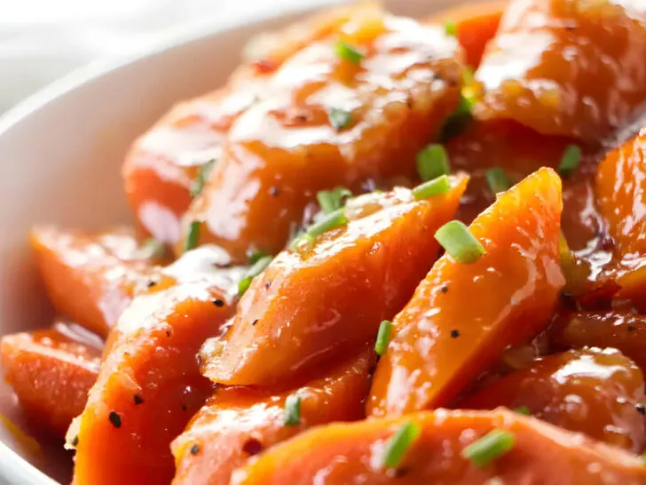 A serving bowl filled with instant pot honey glazed carrots.