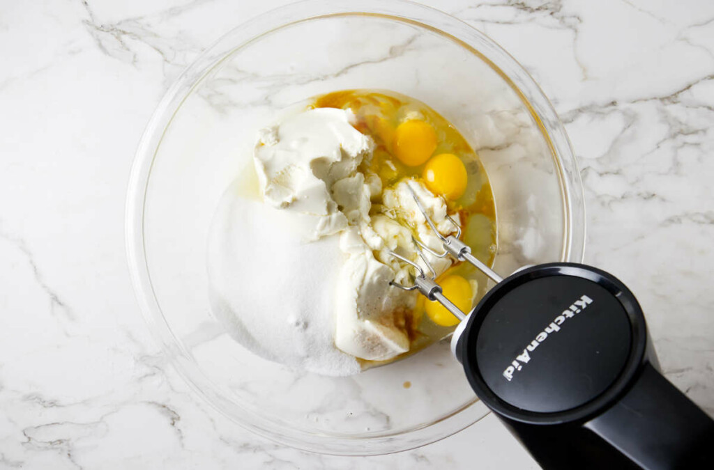 Blending ricotta with sugar and eggs.