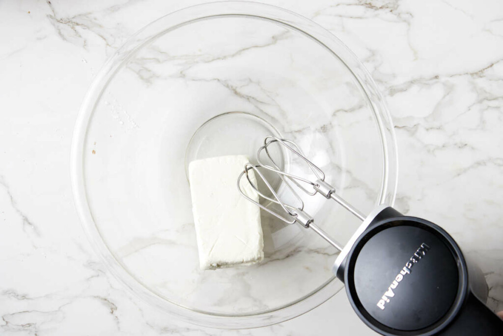 A block of cream cheese in a bowl.