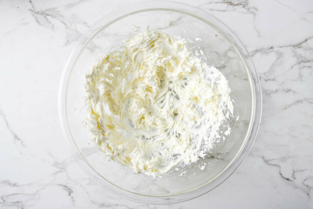 Beating cream cheese to get it soft.