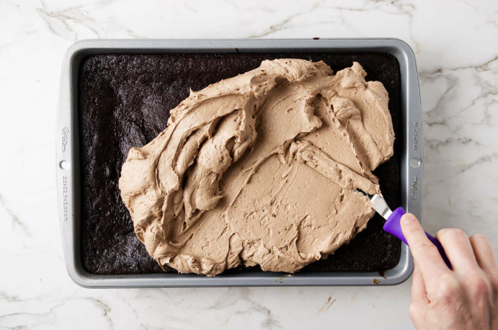 Spreading frosting on a sheet cake.