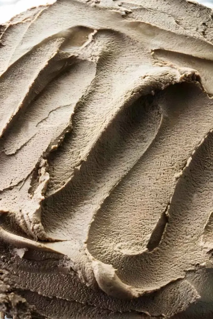 A spoon smoothed through nutella cake filling to show the texture.