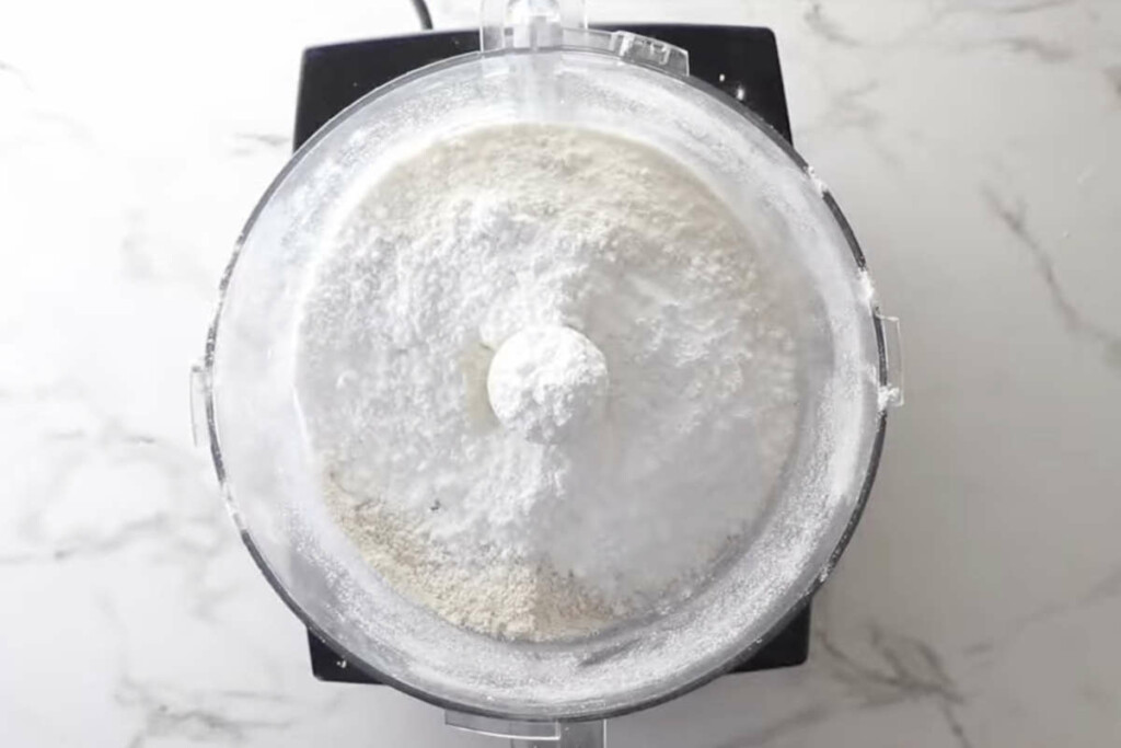 Adding all purpose flour, sugar and salt to the food processor.