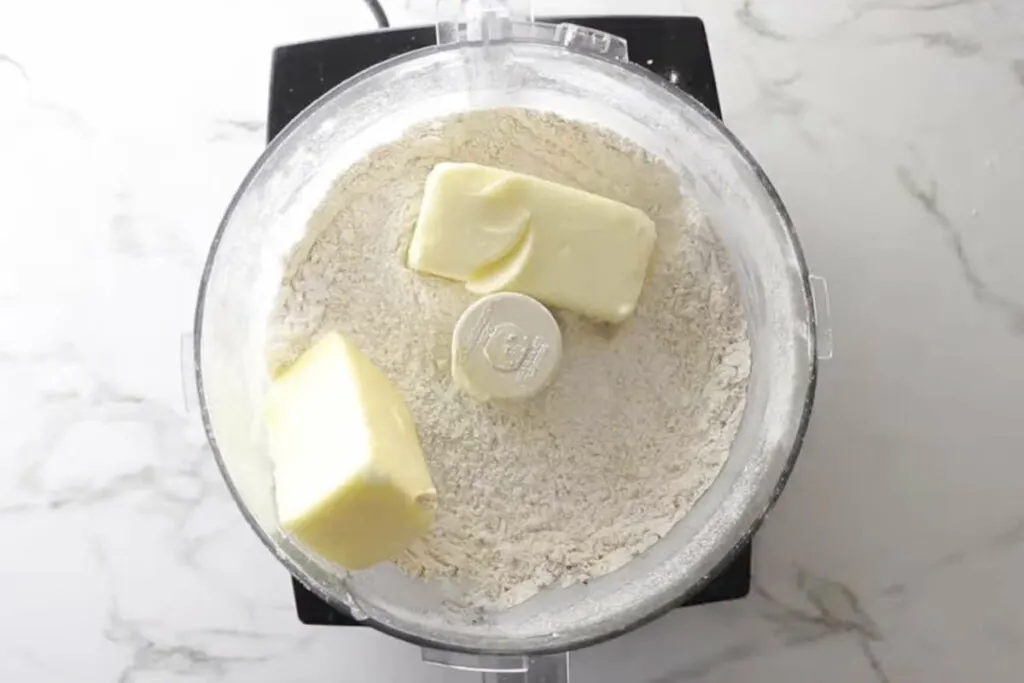 Two sticks of butter in the food processor to get blended with the flour mixture.