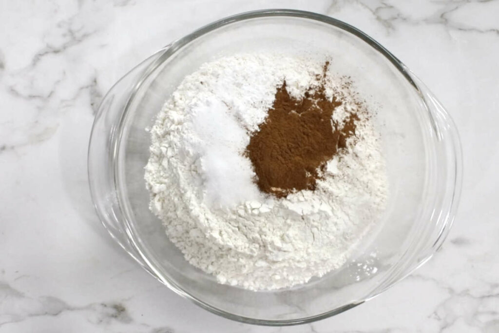 Whisking flour and spices in a bowl.