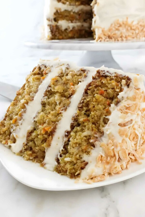 A slice of pineapple carrot cake with three layers.