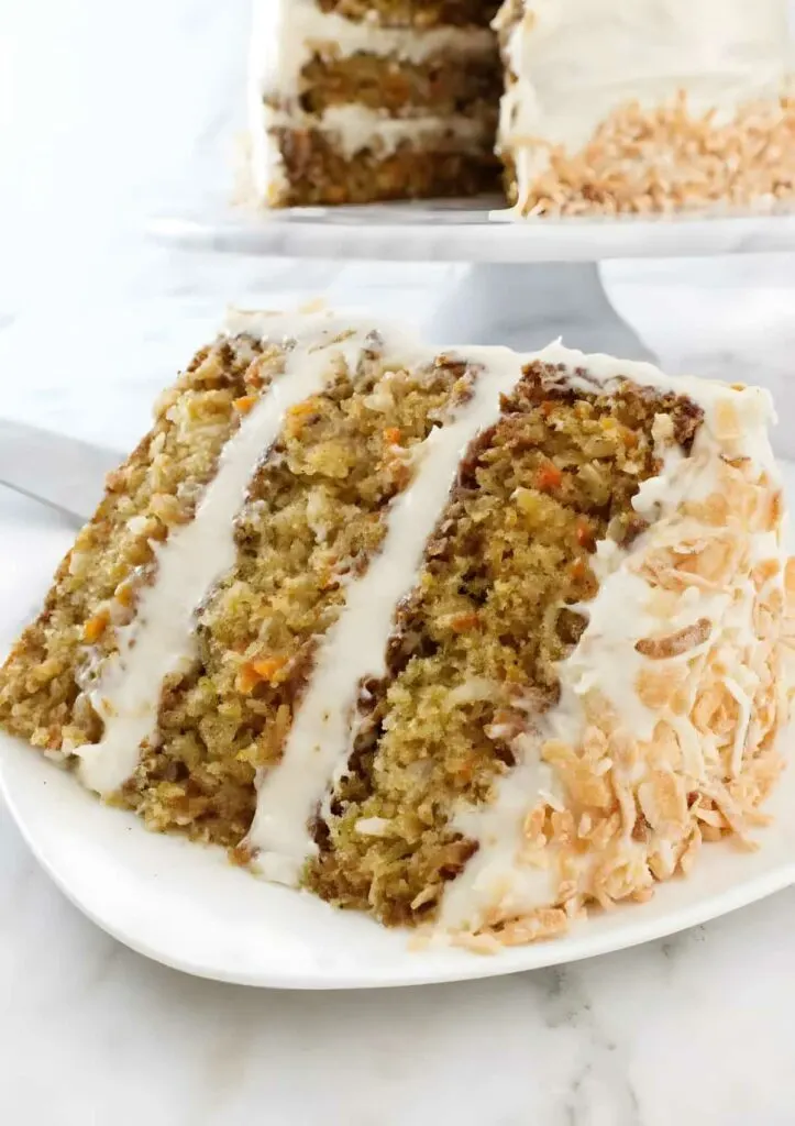 A slice of pineapple carrot cake with three layers.