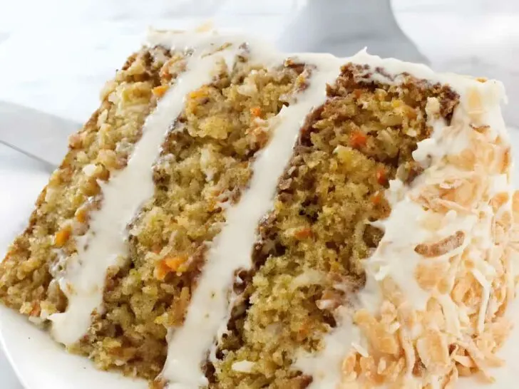 A slice of pineapple carrot cake with three layers.