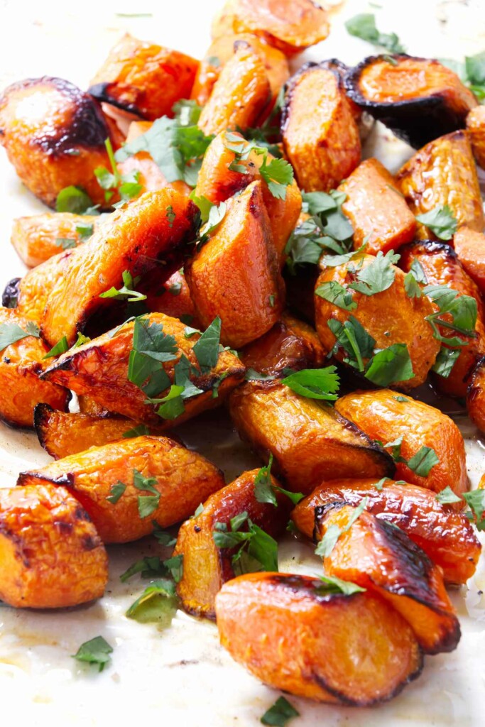 Cilantro scattered on a serving of carrots roasted in the oven.