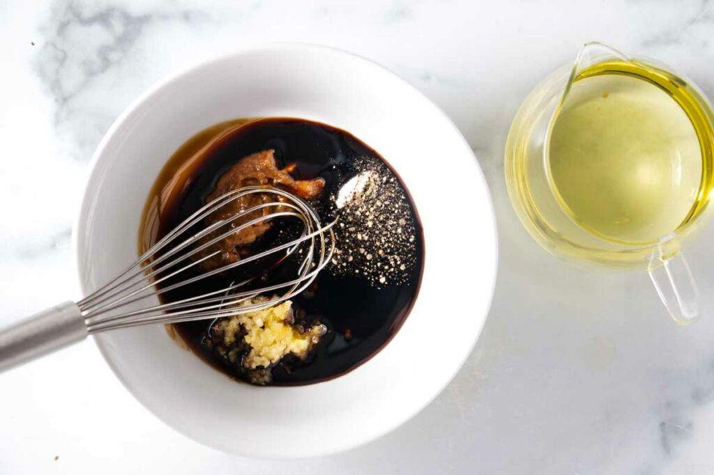 Whisking ingredients for a balsamic dressing.