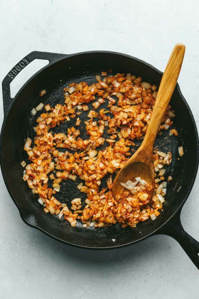 Cooking onions to show how to make stuffed cabbage.