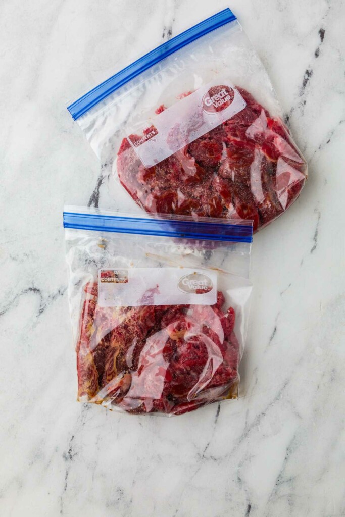 Velveting steak strips in a marinade.