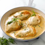 Creamy tarragon chicken breasts in a skillet.