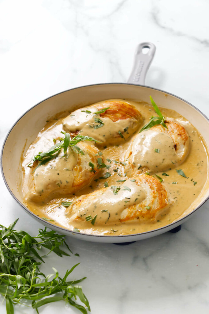 Creamy tarragon chicken breasts in a skillet.