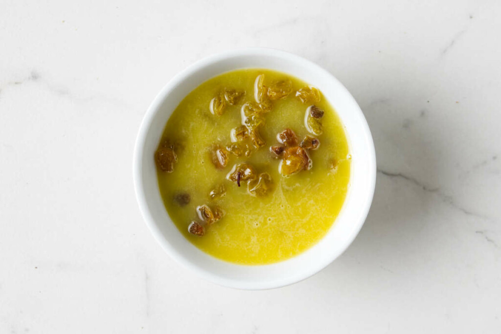 Soaking raisins in orange juice.