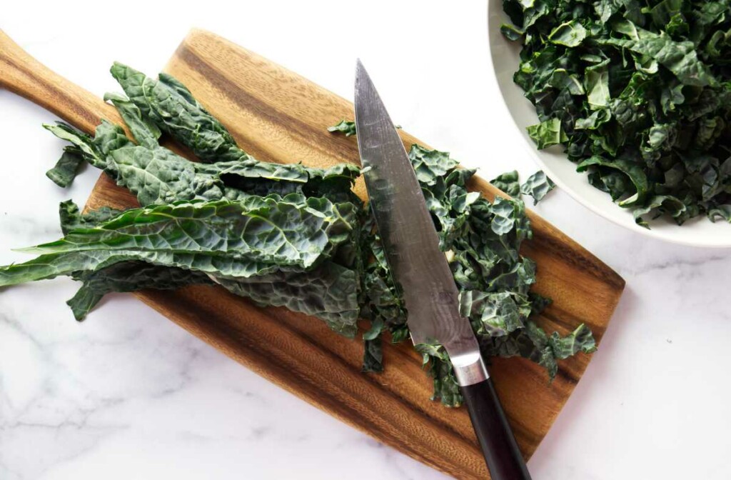 Cutting kale leaves with a knife.