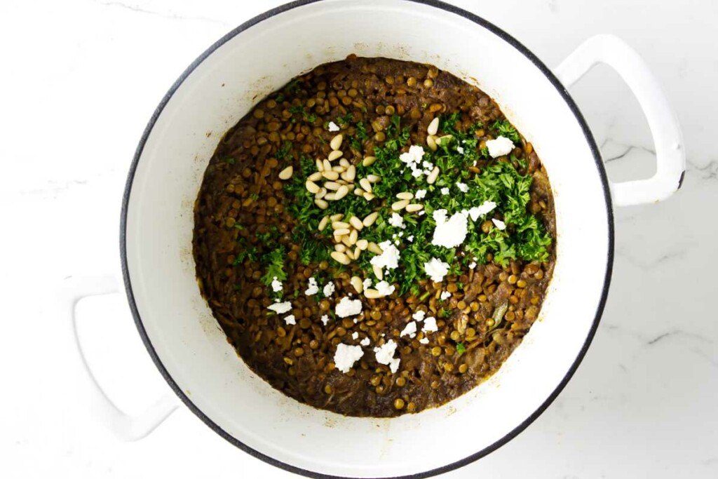 Topping lentils and rice with parsley, feta, and pine nuts.