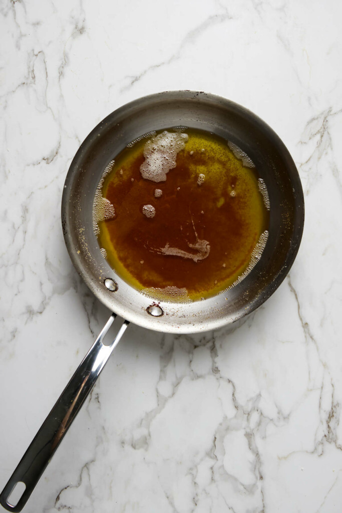 Stainless steel pan with rich golden brown browned butter.