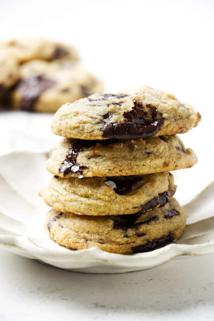 A stack of four sourdough discard cookies on a textured plate.