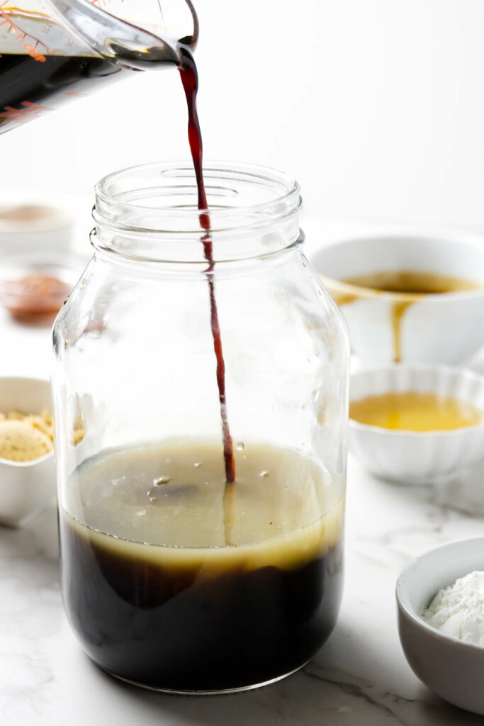 Showing how to make stir fry sauce by adding ingredients to a jar.