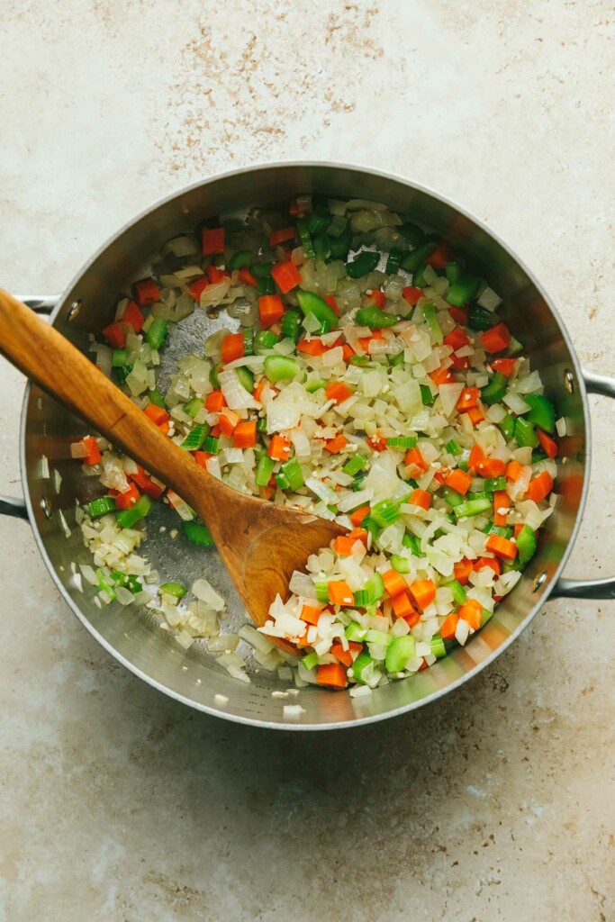 Sauteeing carrots and celery to make a recipe for cabbage roll soup