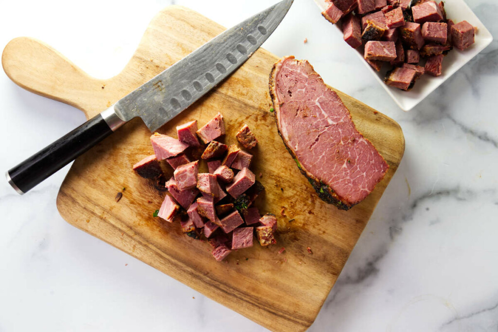 Slicing corned beef to make corned beef and potatoes.