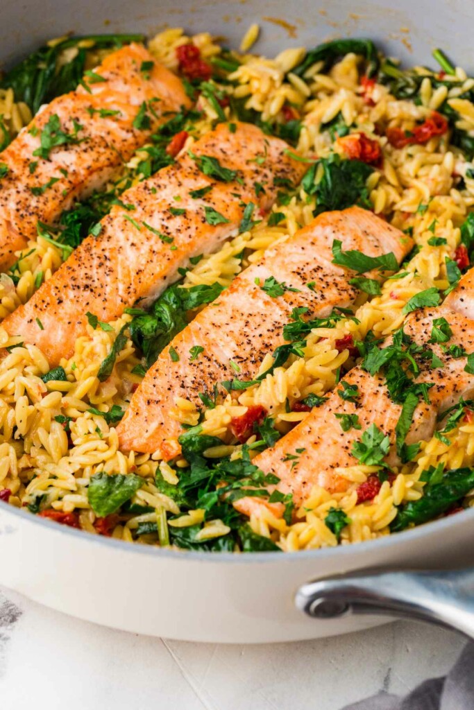 Salmon lemon orzo in a pan.