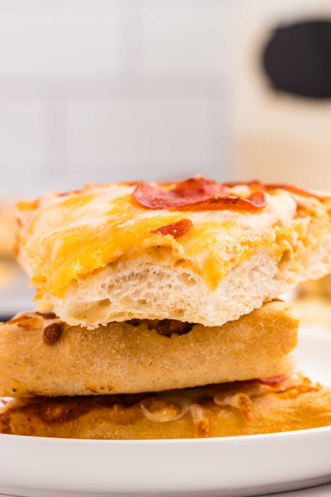 Three slices of pizza dough on a white plate.