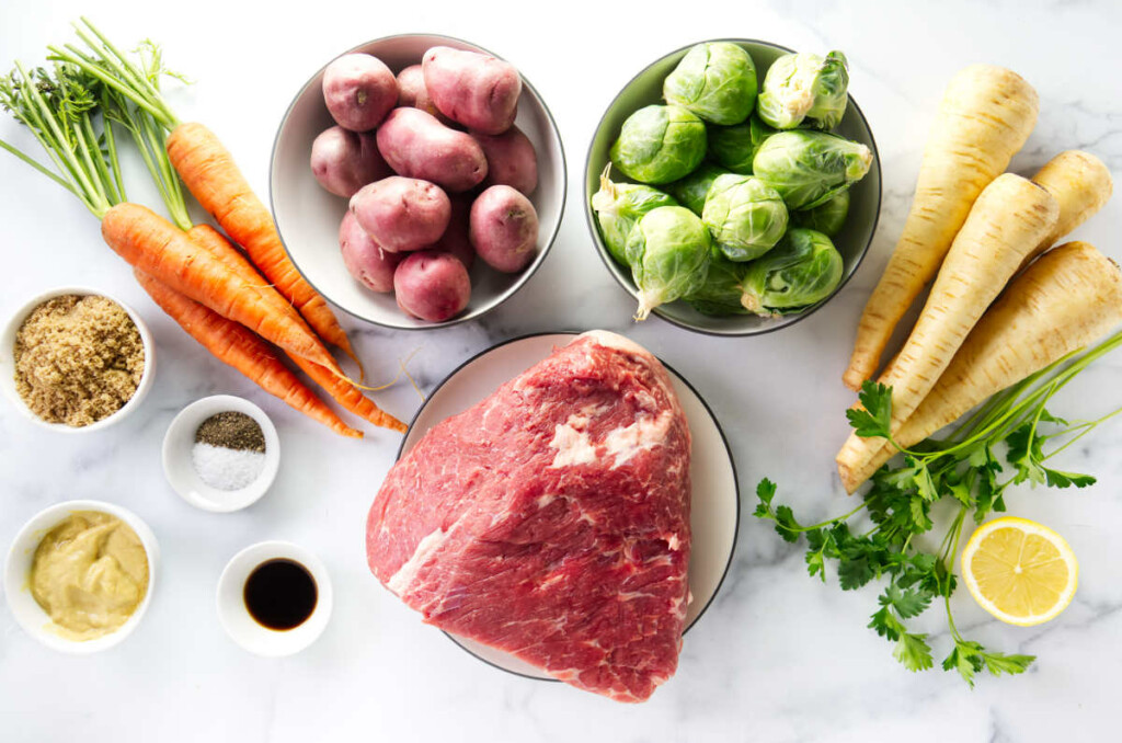 Ingredients to make sheet pan corned beef with Brussels, carrots, and potatoes.