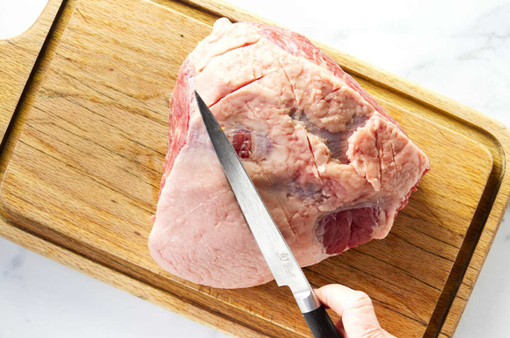 Slicing the fat off a corned beef.