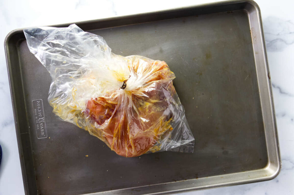 Wrapping corned beef in an oven roasting bag.