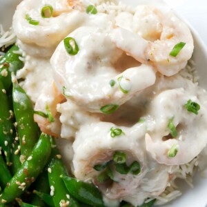 Creamy shrimp over rice with green onions, sugar snap peas, sesame seeds.