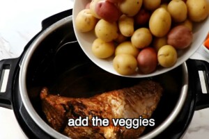 Bowl of potatoes added to pressure cooker with cooked meat, add the veggies.