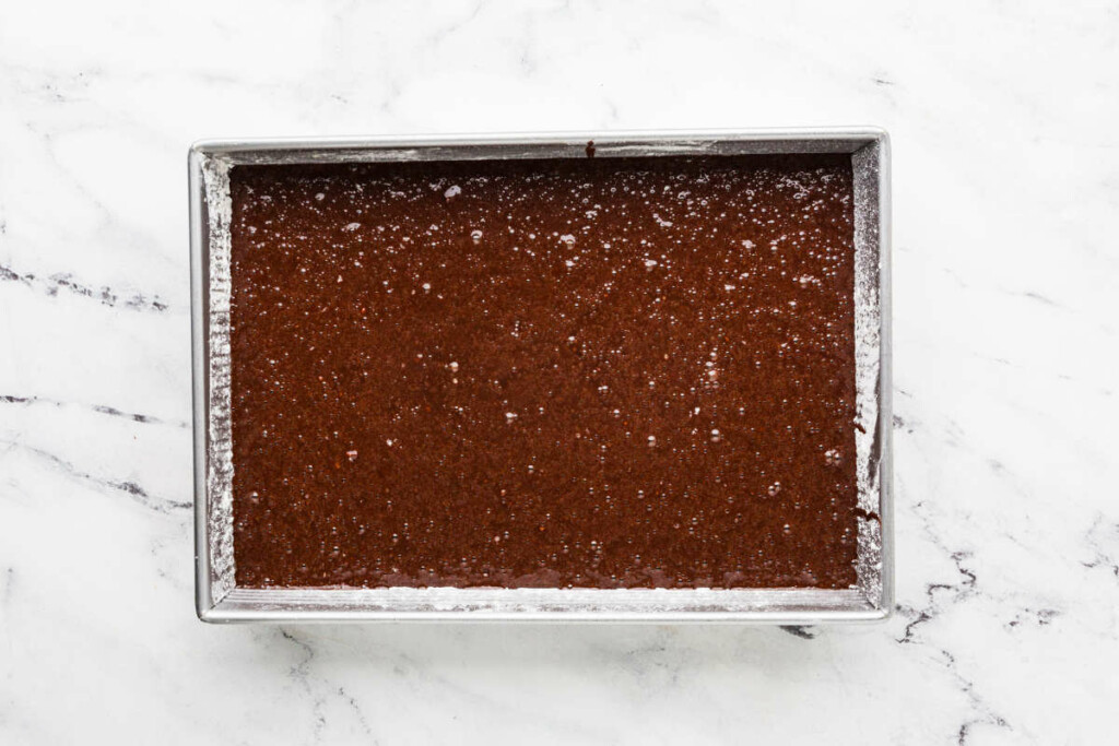 Spreading the cake batter in a 13 x 9 inch cake pan.