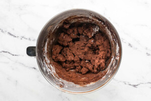 Beating in the powdered sugar to make chocolate buttercream.