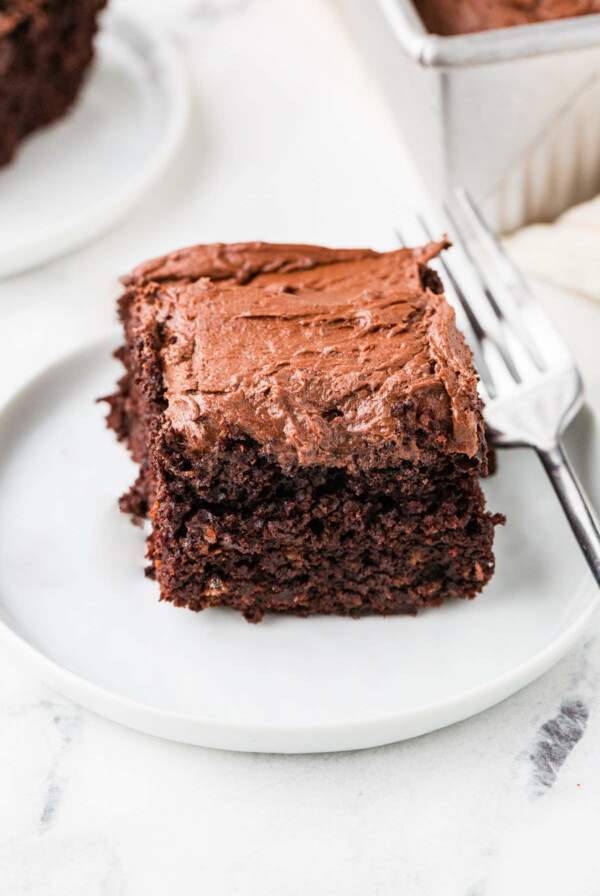 A slice of chocolate sourdough cake topped with chocolate buttercream.