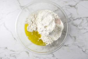 Combining all the ingredients in a mixing bowl.