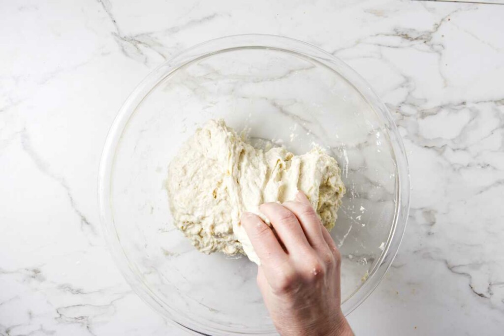 Doing stretch and folds to sourdough dough.