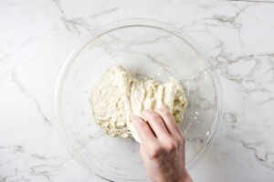 Doing stretch and folds to sourdough dough.