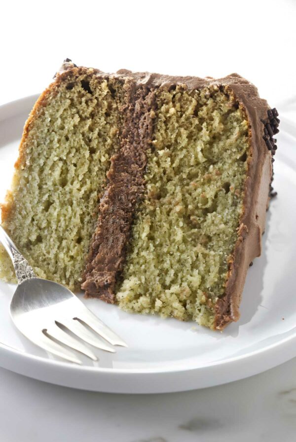 A slice of banana layer cake with nutella frosting.