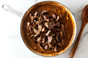Adding the beef strips back to the stroganoff sauce.