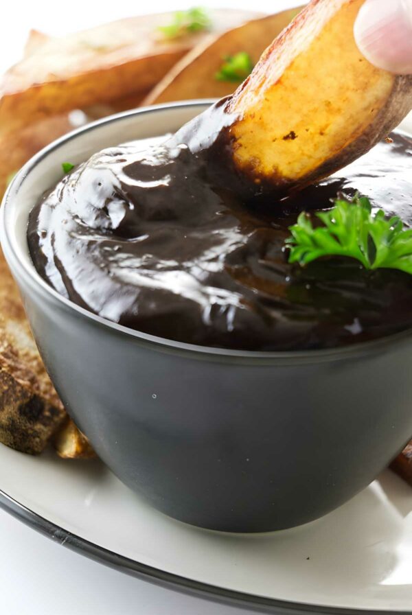 Potato wedge dipped black garlic aioli.