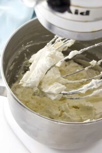 Whipping ermine frosting in a bowl of a stand mixer.