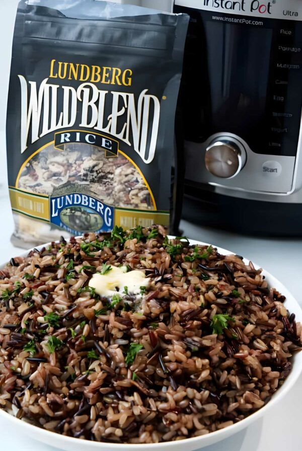 Bowl of wild blend rice with butter, herbs, Instant Pot, and rice bag.