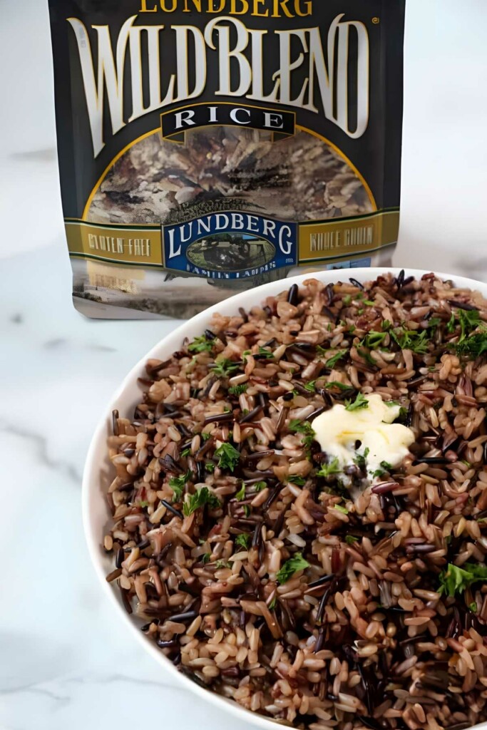 Bowl of wild blend rice with butter, herbs, and Lundberg rice package.