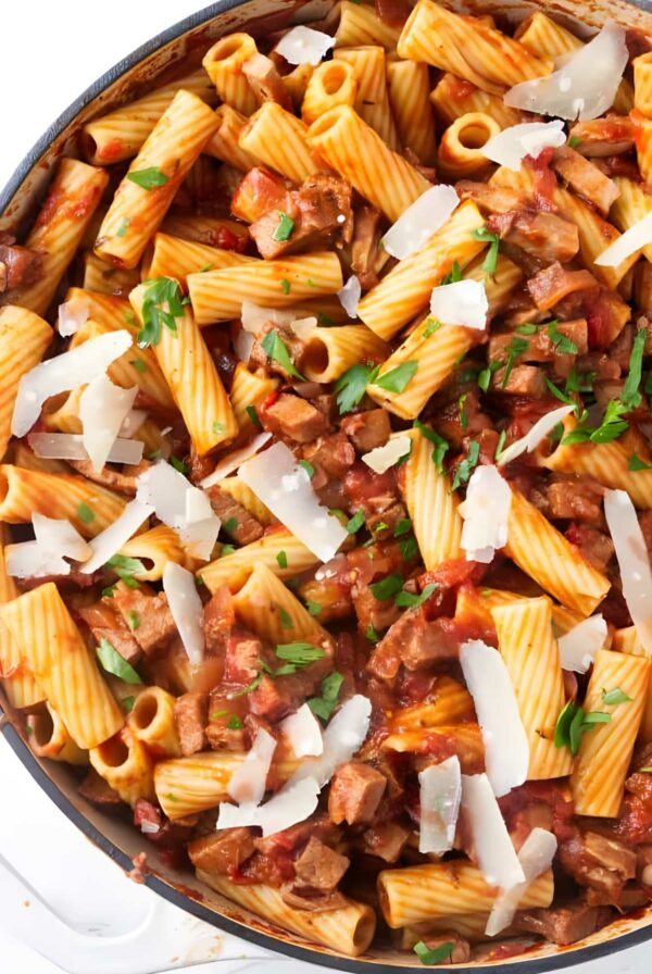Rigatoni pasta with beef in a skillet.