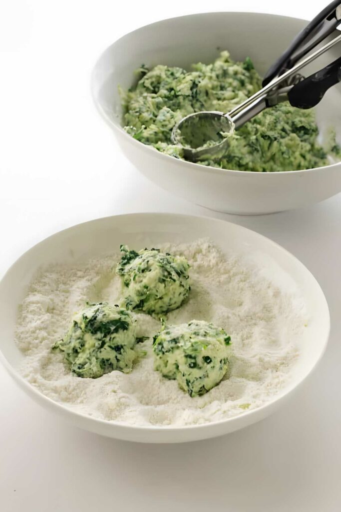 Spinach and ricotta mixture scooped onto flour.