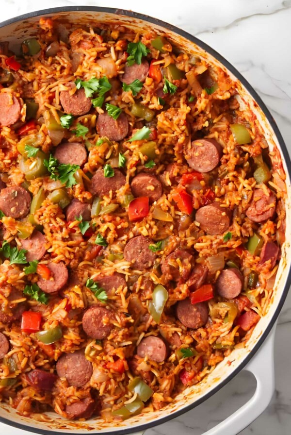 Skillet of rice with sausage, peppers, onions, and parsley.